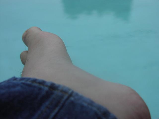 Dangling feet over pool