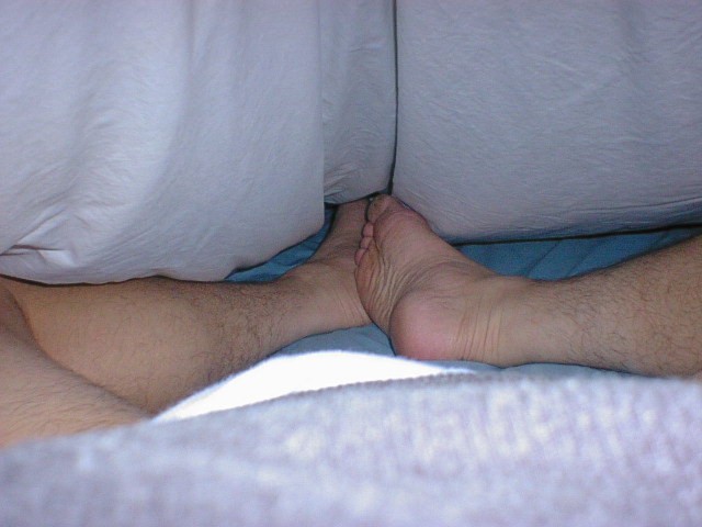 Frank shows off his feet in bed