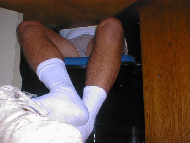 Frank shows his socks under his desk