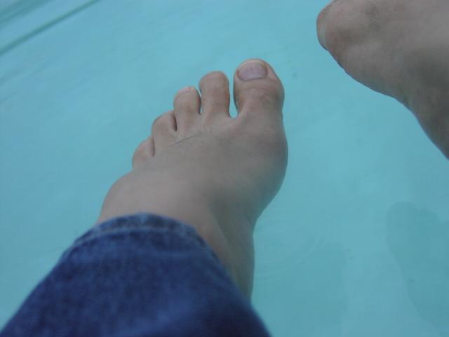 Feet going into the pool