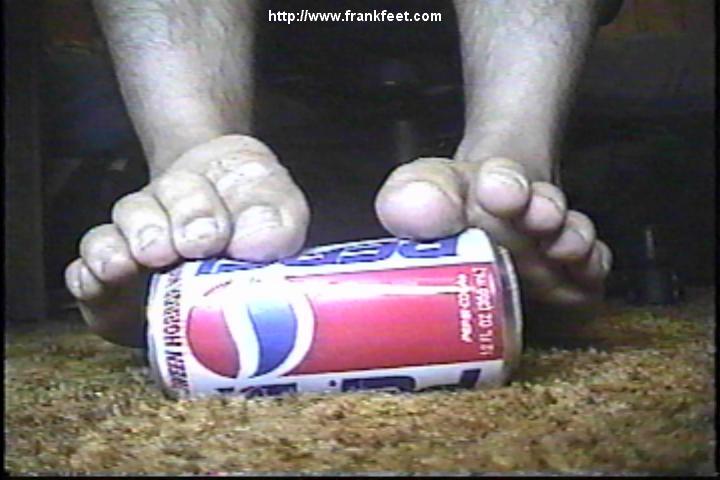 Feet crushing a soda can.